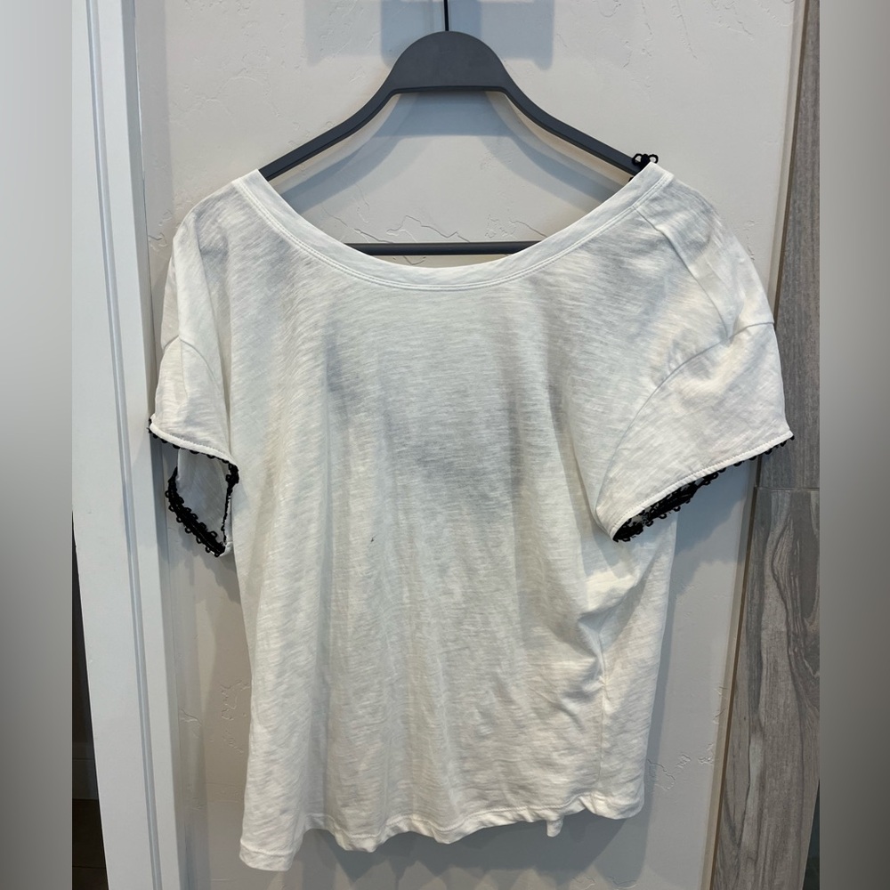 Plain white tea with an open back lined with black lace